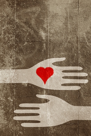 hands giving heart on urban surface