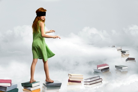 woman blindfolded walking on books