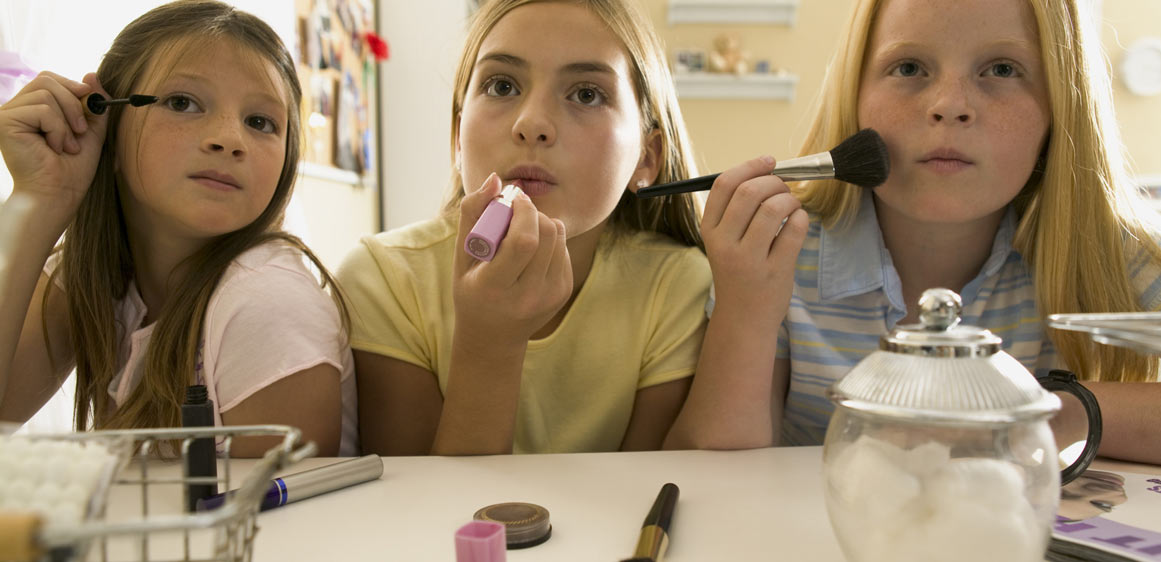 Young girls applying makeup