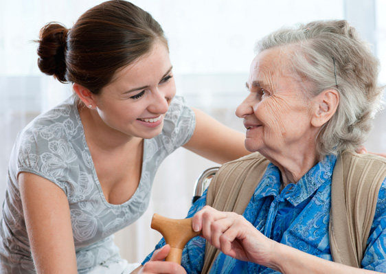 Young woman caring for senior woman