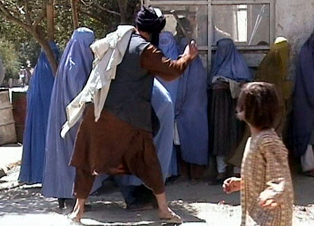 Taliban beating woman for removing burqa