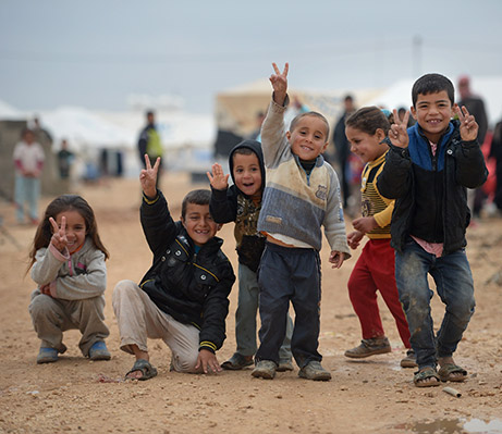 Children pose for a picture Syrian refugee camp