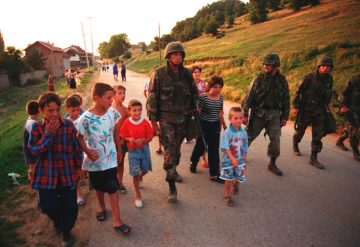 US Marines escort Albanian children during Kosovo war