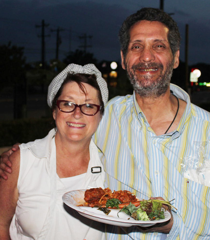 Chef Joan Cheever serving food to a homeless man