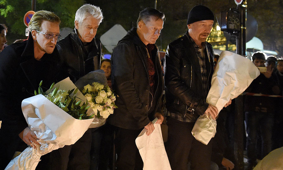 U2 placing flowers at Bataclan Memorial in Paris, honoring the victims of the November attacks