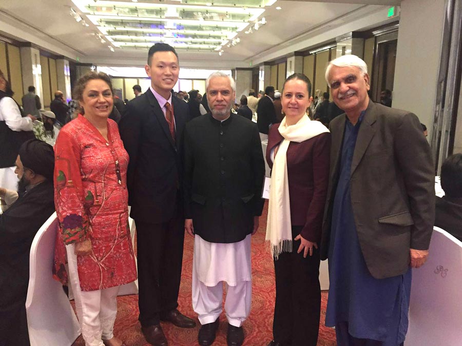 Representatives of the Baha’i International Community with the Secretary of Pakistan’s Ministry of Religious Affairs (center) at the International Seerat Conference held in Lahore. 