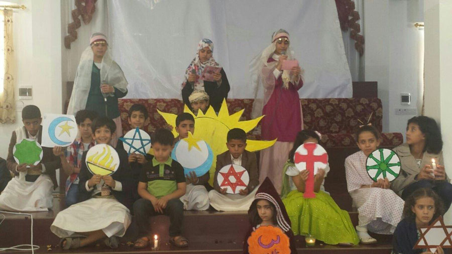 Children celebrating the commonalities of all faiths at a community event.