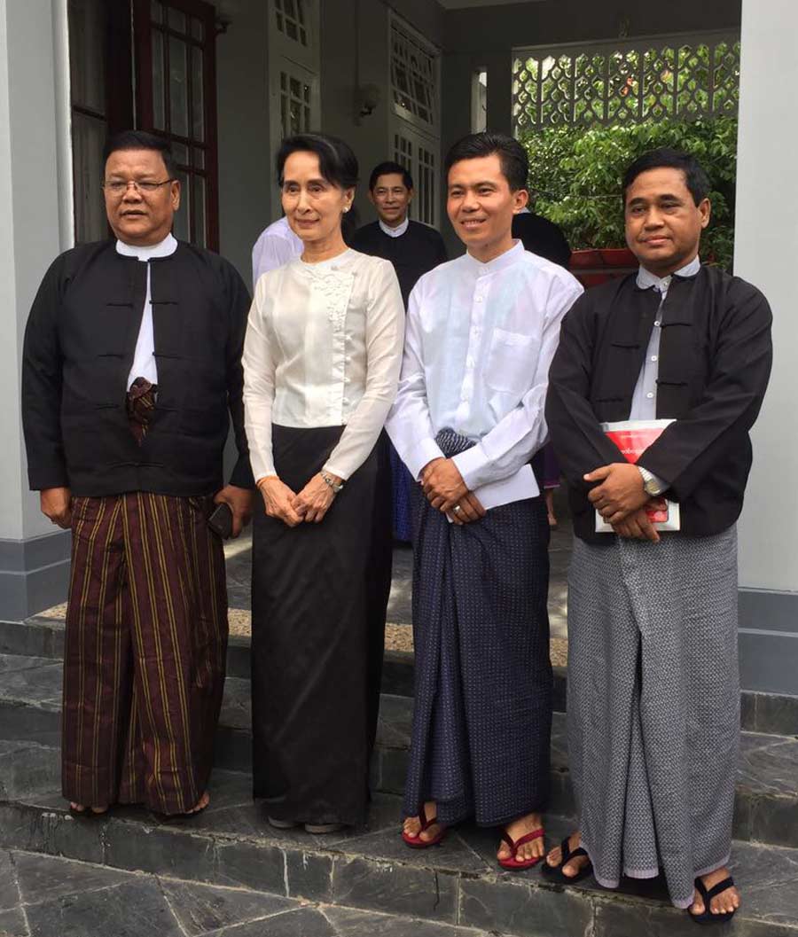 Aung San Suu Kyi (center left) with representatives of the Baha'i community of Myanmar (from left to right: U Shwe Thee, U Myint Zaw Oo, U Tin Win)