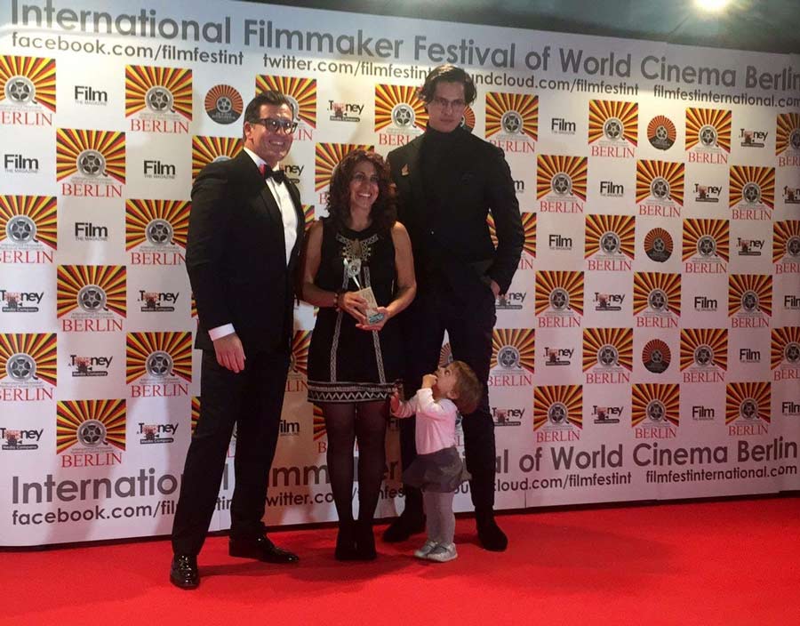 Writer and director May Taherzadeh (center) and Editor and Assistant Cameraman, Heinrich Nuesslein (right), receive an award for “Best Short Foreign Language Film” and “Best Editing for a Foreign Language Film” at the International Filmmaker Festival of World Cinema in Berlin 2016.