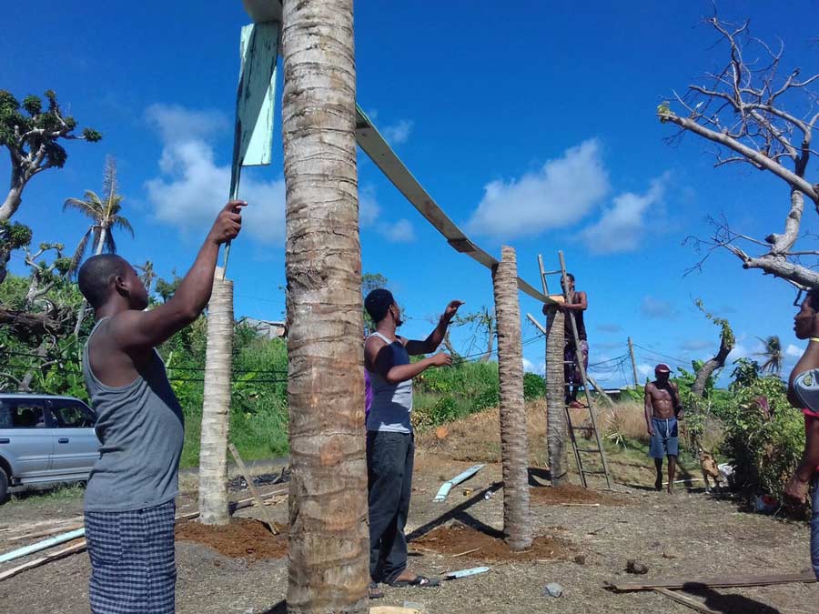 In the months following September 2017, when Hurricane Maria devastated the Caribbean island of Dominica, the community united in reconstruction efforts. Here, youth and adults work together to build a greenhouse in the island’s Kalinago territory.