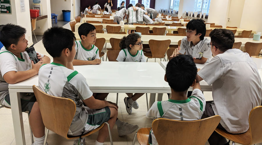 Two high school students support a group of middle school students as part of the school’s moral empowerment program.