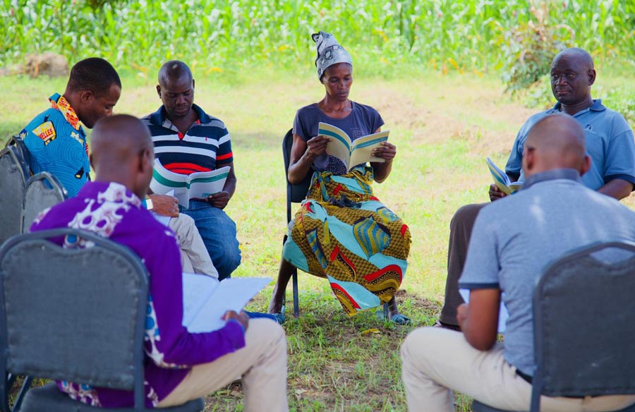A group of participants in one of Inshindo Foundation’s educational programs studies at the Ngungu Center for Community Agriculture.