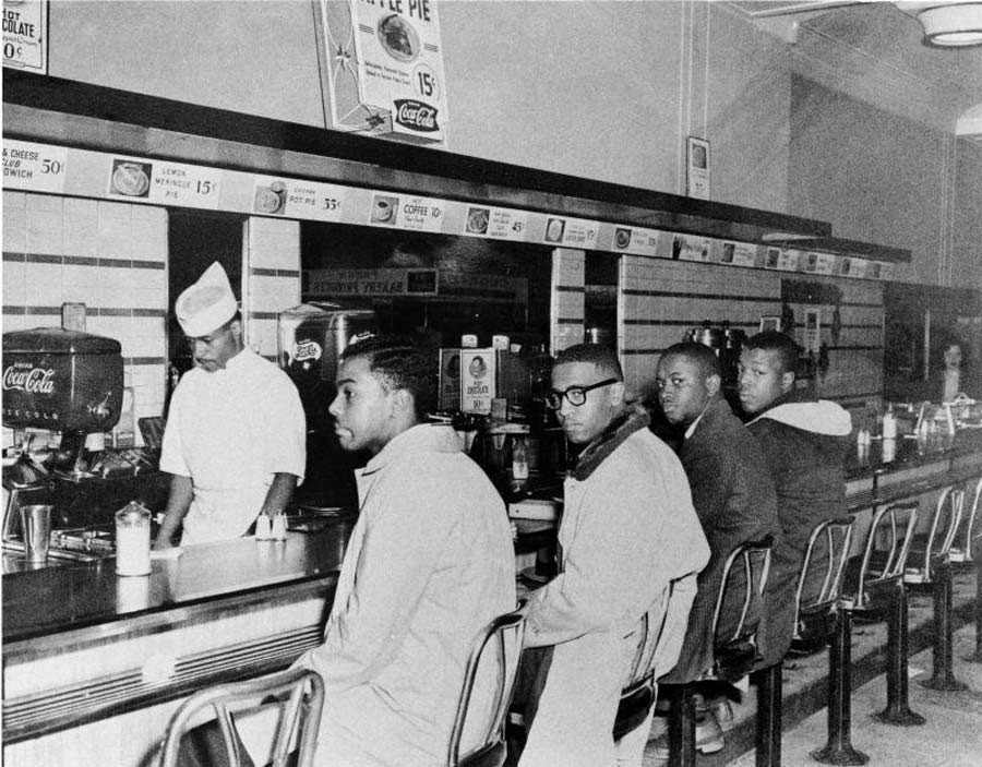 A photograph of a protest conducted at a Woolworth’s lunch counter shows a young Van Gilmer amongst the student activists.