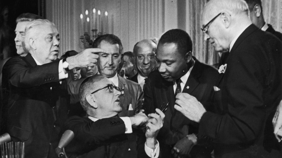 President Lyndon Johnson congratulates the Rev. Martin Luther King Jr. at the signing of the 1964 Civil Rights Act.