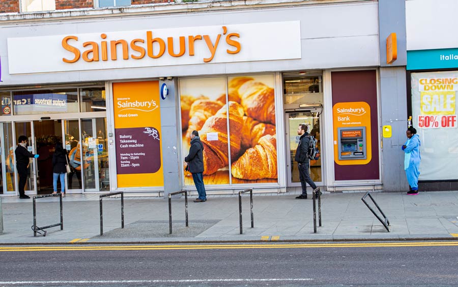 Social distancing in front of Sainsbury’s Wood Green, London, during the Coronavirus pandemic. 26 March 2020.