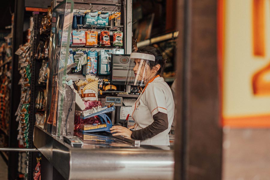 Supermarket cashier wearing mask on a supermarket on Aclimação neighborhood in São Paulo, Brazil during coronavirus quarantine.