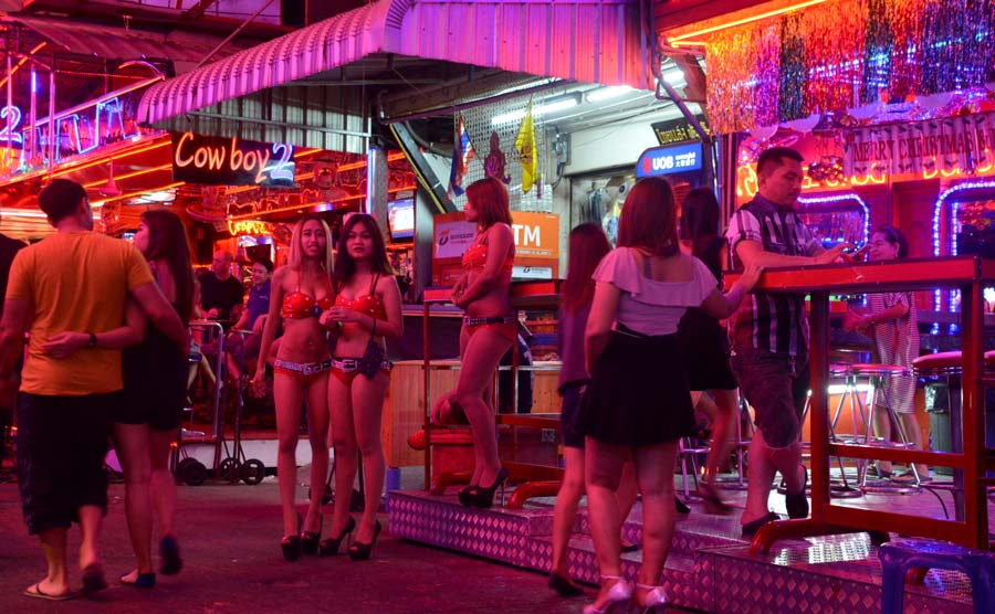 Bangkok, Thailand - January 2, 2016: Thai women outside a Go-go Bar in Soi Cowboy, a short walking street of bars and strip clubs in the Asok-Sukhumvit district.