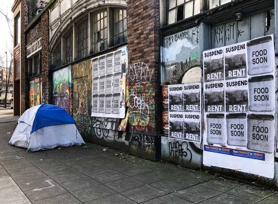 Boarded up businesses with rent strike posters in Seattle, WA (March 31, 2020).