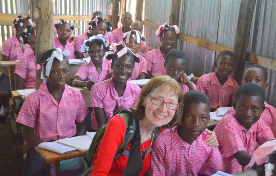 Dr. Mary Sue Carlson with school children in Haiti.