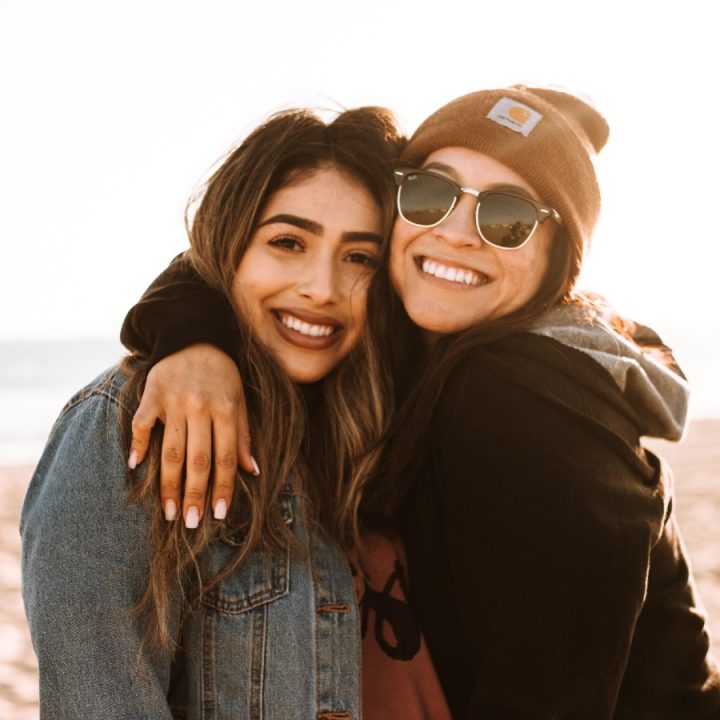 Two friends hugging at the beach