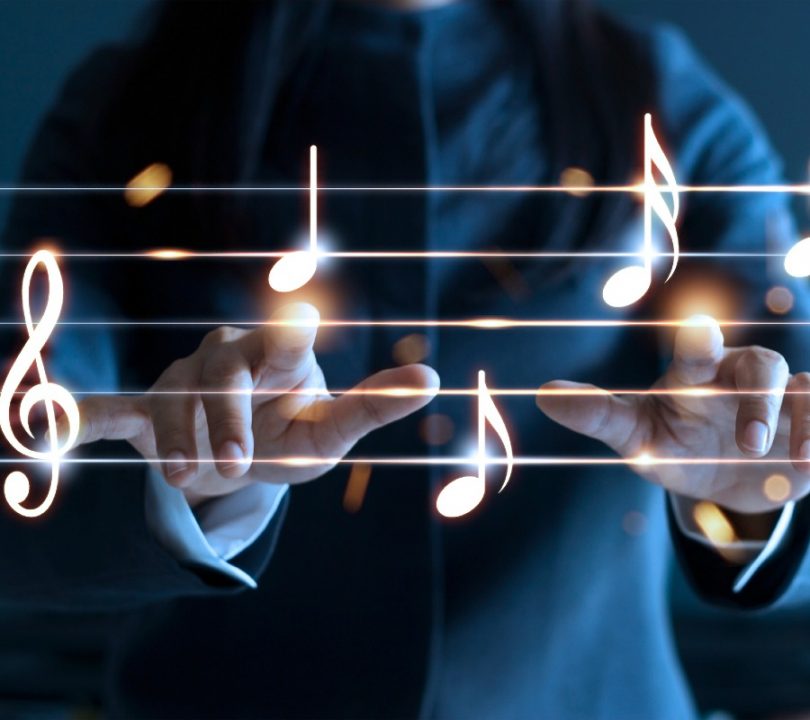 A musician pointing to musical notes in the air