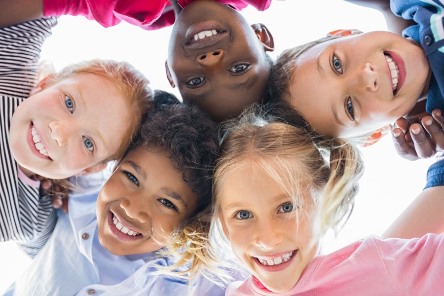 A group of diverse children hugging