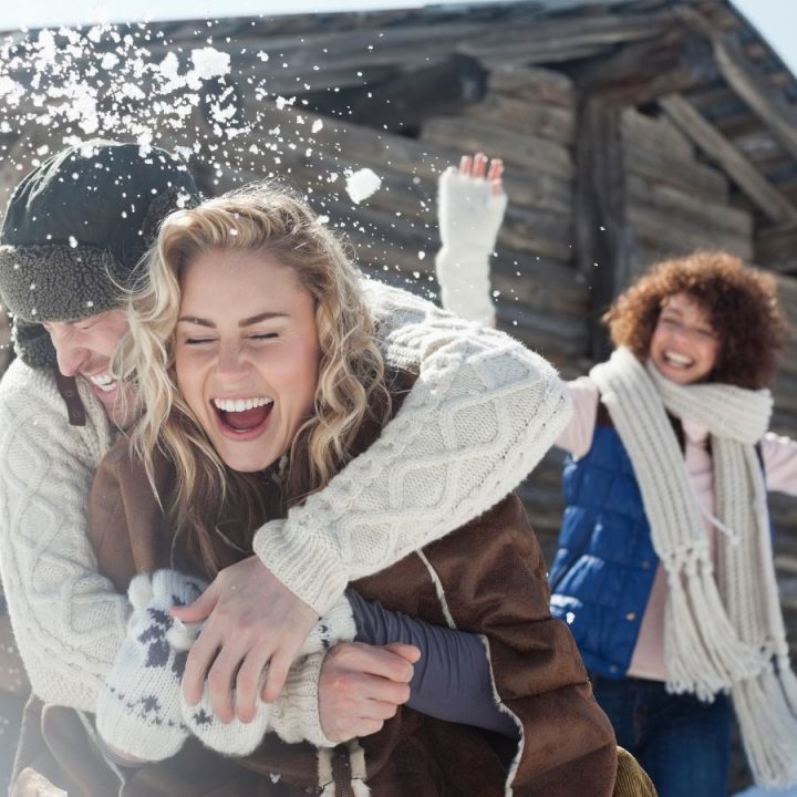 People laughing during a snowball fight
