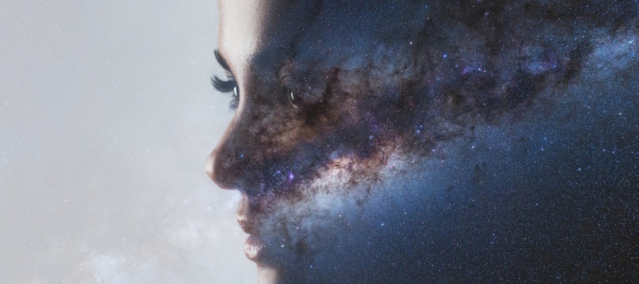 a mystical image of a woman's face encompassing the universe