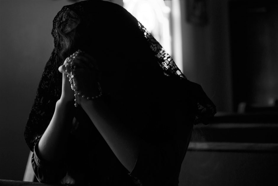 A woman grieving and praying