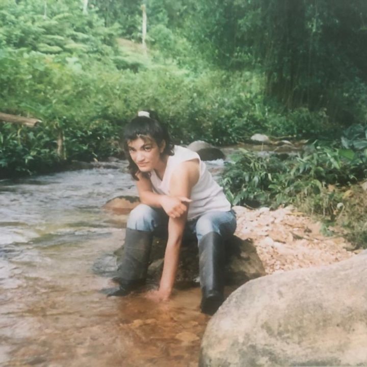 Ymasumac sticking her hand in the mud