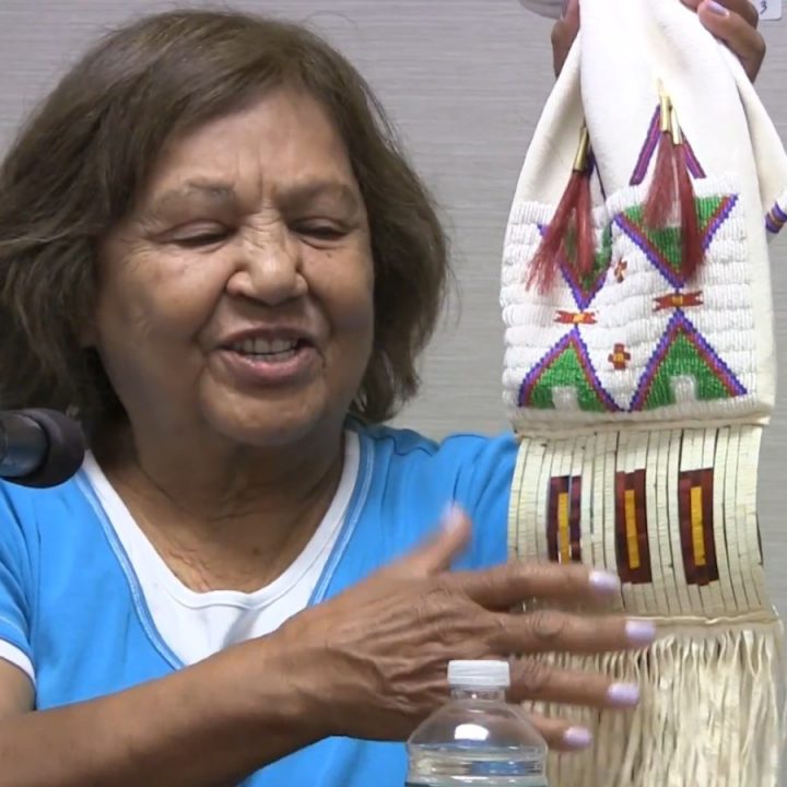 Ina McNeil points to the section of the pipe bag she made that used porcupine quillwork.