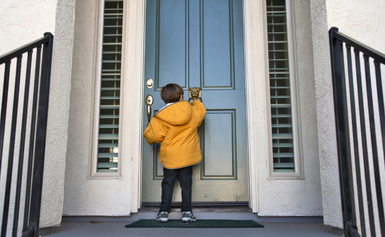 A child knocking on a door.